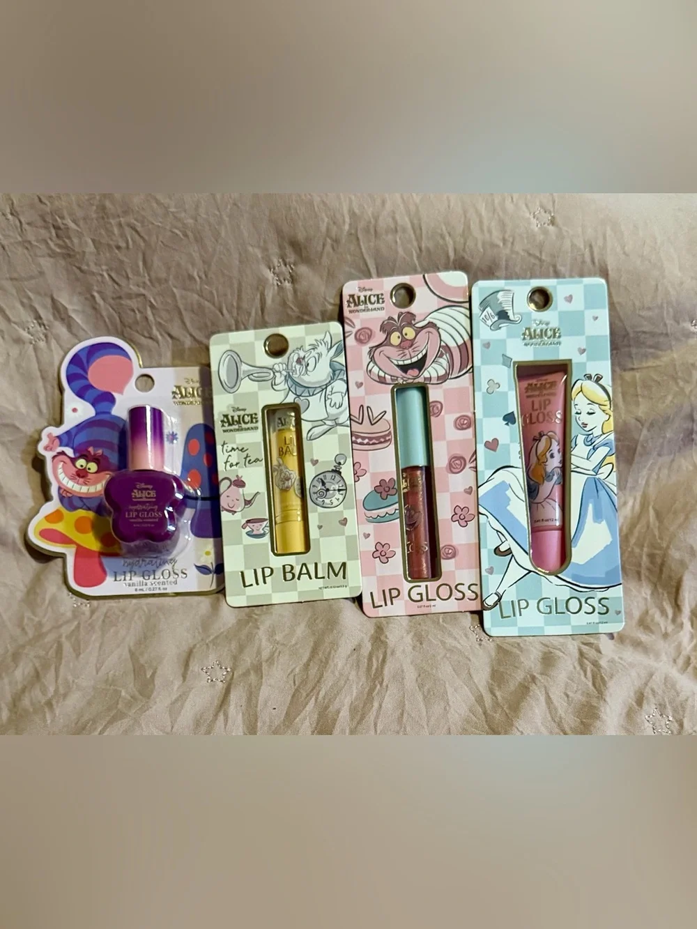 4 piece Alice in Wonderland Lip Gloss & Balm Set - Purple, Gold, Pink, Blue